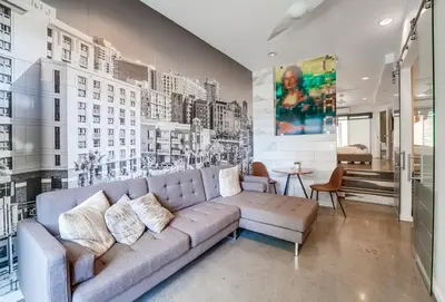 a living room with a couch and a wall with buildings at Kettner Row 1 in San Diego