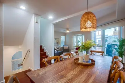 a dining room and living room with a table and chairs at Palms Paradise 1 in San Diego