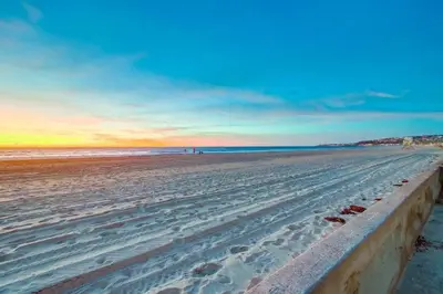 a view of a beach at sunset with the ocean at Strandway Suite 2 in San Diego