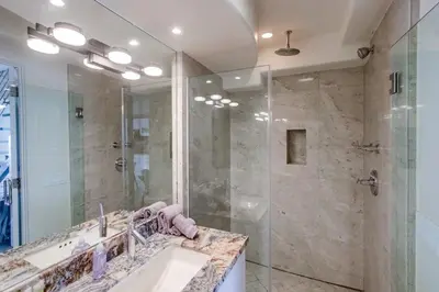 a bathroom with a shower and a sink and a mirror at Surf Style 1 in San Diego