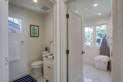 a white bathroom with a toilet and a window at The Shores 2 in San Diego