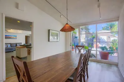 a dining room with a large wooden table and chairs at Treasure Villa in San Diego