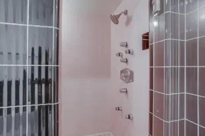 a bathroom with a shower with a glass door at Treasure Villa in San Diego