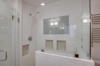 a white bathroom with a shower and a sink at Treasure Villa in San Diego