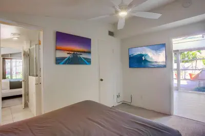 a bedroom with a bed and two pictures on the wall at Treasure Villa in San Diego