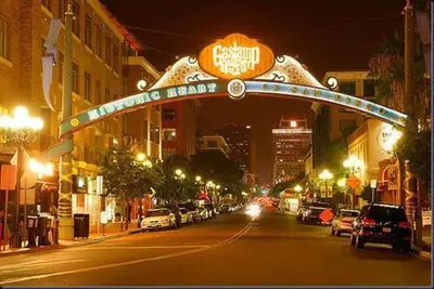 a city street at night with a sign for a moving lane at 28 NIGHT MINIMUM in the Gaslamp Quarter by Petco Park, pool, jacuzzi, dogs ok in San Diego