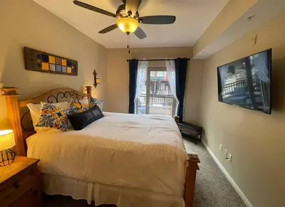 a bedroom with a bed with a ceiling fan at 28 NIGHT MINIMUM in the Gaslamp Quarter by Petco Park, pool, jacuzzi, dogs ok in San Diego