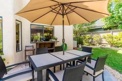 a table and chairs with an umbrella on a patio at Escape to Carmel Valley Tranquil Outdoor Space in San Diego