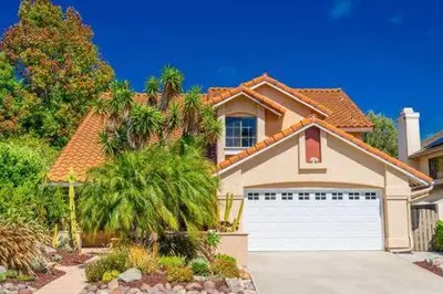 a house with a white garage and a palm tree at Escape to Carmel Valley Tranquil Outdoor Space in San Diego