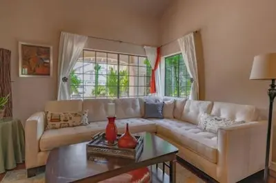 a living room with a white couch and a table at Escape to Carmel Valley Tranquil Outdoor Space in San Diego