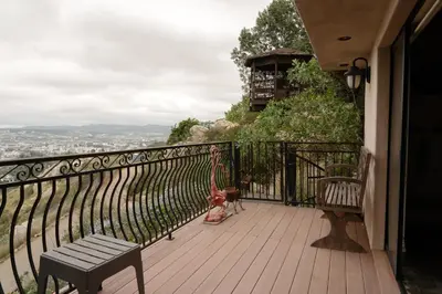 a balcony with a bench and a statue of a dog at Stunning Home & Spectacular View in La Mesa