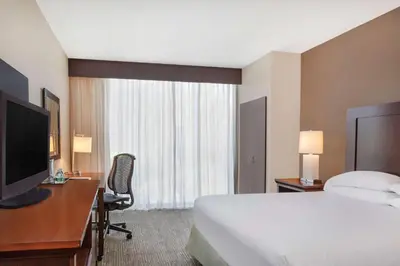 a hotel room with a bed and a desk and a television at Wyndham San Diego Bayside in San Diego