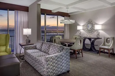 a living room with a couch and a dining room at Wyndham San Diego Bayside in San Diego
