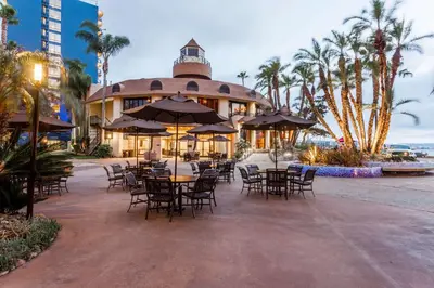 a restaurant with tables and chairs in front of a building at Wyndham San Diego Bayside in San Diego