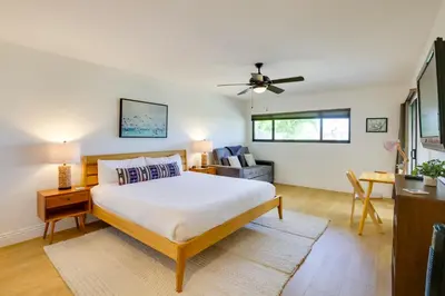 a bedroom with a bed and a living room at Solana Beach Condo with Community Pool, Beach Access in Solana Beach