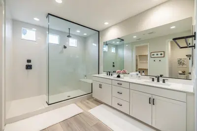 a white bathroom with two sinks and a shower at #Marbella Lane - Elegant 5BR Home Rancho Mission in Ladera Ranch