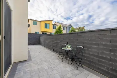 a patio with a table and chairs on a fence at #Marbella Lane - Elegant 5BR Home Rancho Mission in Ladera Ranch