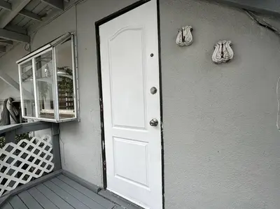 a white door on the side of a house at Beachside 2BR close 2 sand, town in Laguna Beach