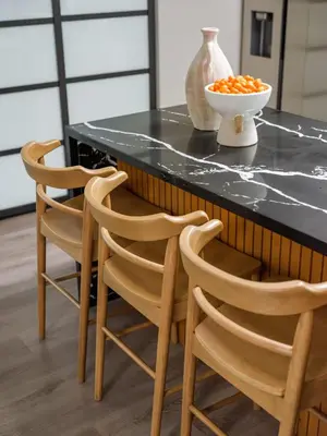a kitchen with two chairs and a table with a bowl of oranges at Peaceful 4br with Fire Pit and Huge Yard in San Diego
