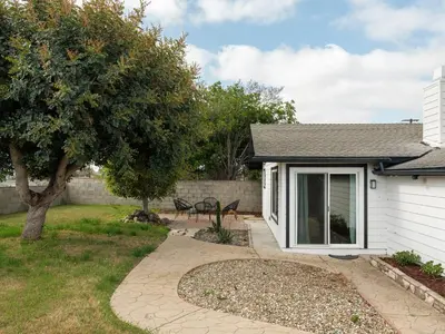 a home with a patio and a yard with a tree at Peaceful 4br with Fire Pit and Huge Yard in San Diego