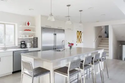 a kitchen with a large white island with chairs at Spacious and Bright 5-Bedroom Oasis Pool and Yard in La Mesa