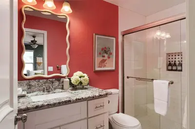 a bathroom with a toilet and a sink and a mirror at Victorian Retreat in Barrio Logan 1mi to Downtown in San Diego