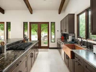 a kitchen with granite counter tops and stainless steel appliances at Private Resort in Lake Hodges in Escondido