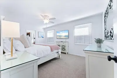 a white bedroom with a bed and a desk at Stunning BayVIEW Home with Epic Waterfront Views! in Newport Beach