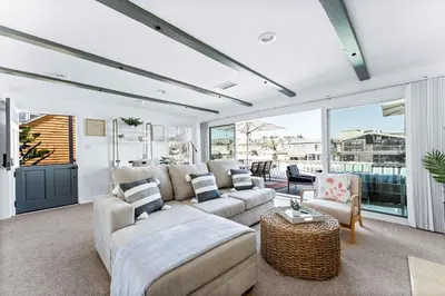 a living room with a couch and a table at Stunning BayVIEW Home with Epic Waterfront Views! in Newport Beach