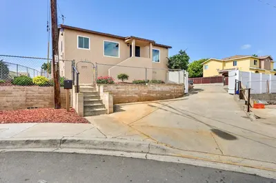 a house on the side of a street at Sunny San Diego Home with Private Yard and Grill! in San Diego