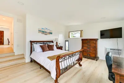 a bedroom with a bed and a flat screen tv at Sunny San Diego Home with Private Yard and Grill! in San Diego