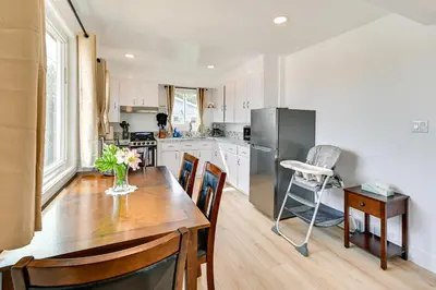 a kitchen with a wooden table and a refrigerator at Sunny San Diego Home with Private Yard and Grill! in San Diego