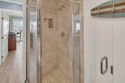 a shower with a glass door in a bathroom at Seaview 1135A in Oceanside