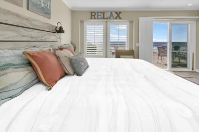 a bedroom with a large white bed with pillows at Seaview 1135A in Oceanside