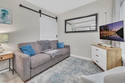 a living room with a couch and a mirror at Tower 9 F in Oceanside
