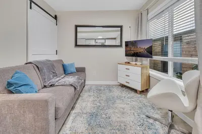 a living room with a couch and a tv at Tower 9 F in Oceanside
