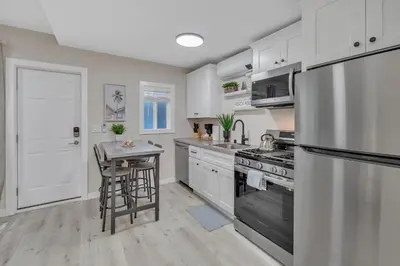 a kitchen with stainless steel appliances and a table at Tower 9 F in Oceanside