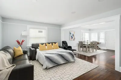 a bedroom with a bed and a couch and a table at Bankers Hill Chic Roomy Home Near Airport in San Diego