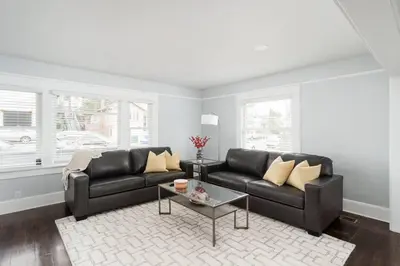 a living room with two black couches and a table at Bankers Hill Chic Roomy Home Near Airport in San Diego