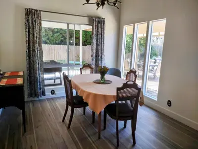 a dining room with a table and chairs and a window at Custom Home - Beach close/convenient to everything in Oceanside