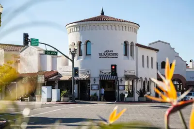 a building with a traffic light in front of a street at WesternWhiteHouseSC in San Clemente