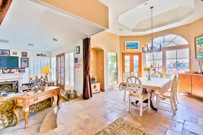 a large living room with a table and chairs at WesternWhiteHouseSC in San Clemente