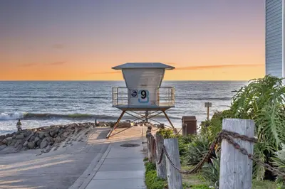 a lifeguard station on the beach at sunset at Seaview 1133A in Oceanside