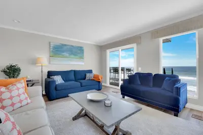 a living room with two blue couches and a table at Seaview 1133A in Oceanside