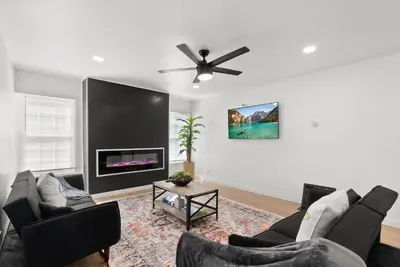 a living room with a couch and a ceiling fan at Safari Vines Retreat in Escondido