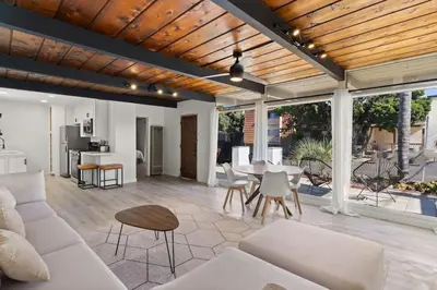 a living room with a couch and a table at Cozy, bright, and walk to Crown Point Park/Bay in San Diego