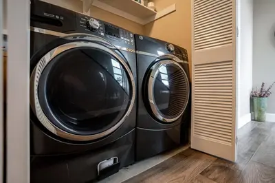 two washing machines sitting next to each other in a room at Bright Designer Oasis - Block from Bay - Roof Deck in San Diego