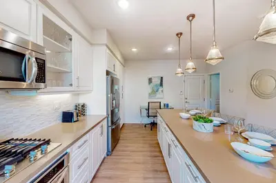 a kitchen with white cabinets and a counter top at Leucadia Stonesteps Retreat in Encinitas