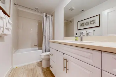 a white bathroom with a sink and a toilet at Leucadia Stonesteps Retreat in Encinitas