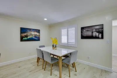 a dining room with a white table and chairs at Centrally Located Retreat 5 Mi to San Diego Zoo! in San Diego